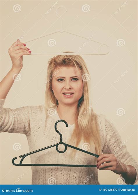 blonde woman holding clothes hanger stock image image of domestic hanging 102126877