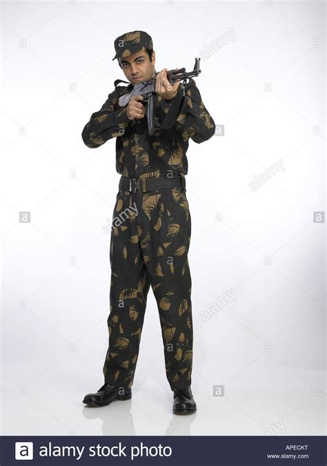 Indian Army Soldier Standing And Pointing Ak 47 Gun Stock