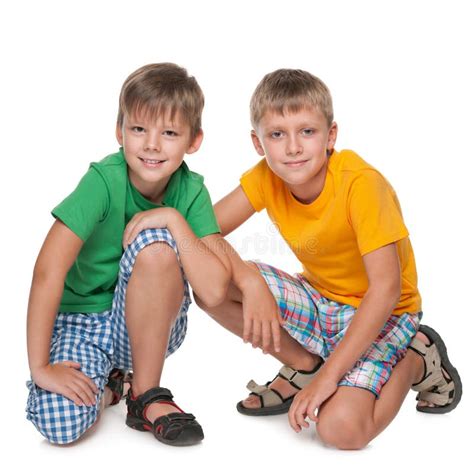 Two Young Boys Are Sitting Together Stock Image Image Of Smile