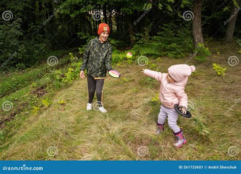 Brother With His Little Sister Play In Autumn Forest Catch And Toss