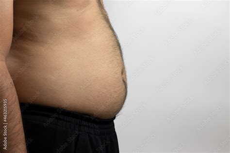 Side View Photo Of A Shirtless Man With A Rather Fat Bulging Body And Hair On The Chest