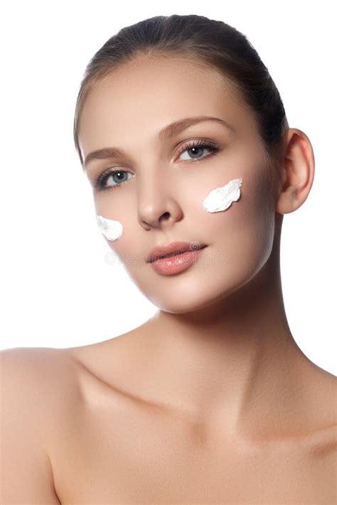 Beautiful Face Of Young Woman With Cosmetic Cream On A Cheek Skin Care