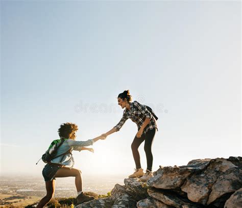 Female Friends Hiking Help Each Other In Mountains Stock Image Image