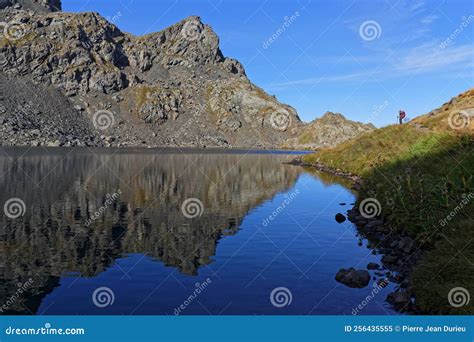 Hiker Admires The View Of Early Morning Lights On Blue Mountain Lake