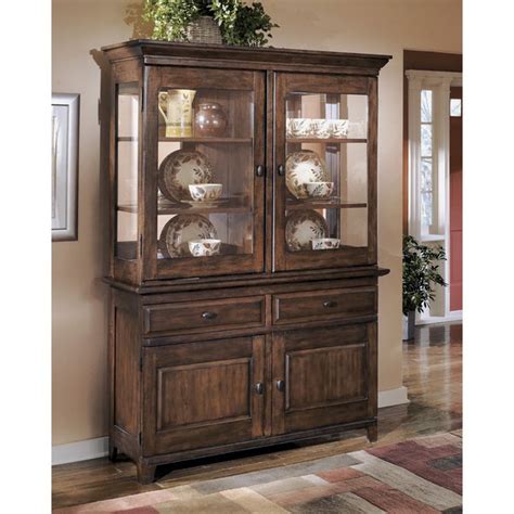 Place fine china inside three amply sized brass and glass paned door front cabinets that feature. Signature Design by Ashley Larchmont Dining Room China ...