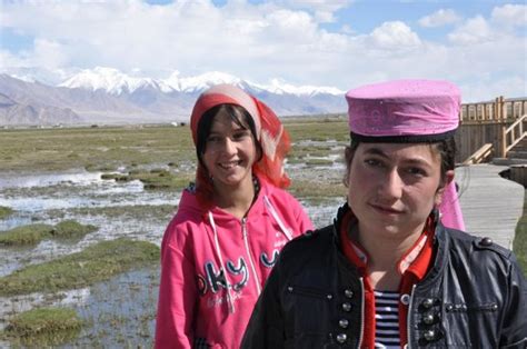 Tajik Girls On The Grasslands Below Picture Of Tashkurgan Fort