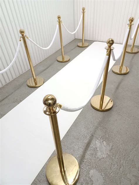 Gold Stanchions With White Ropes And White Carpet Runner Carnival Rides Karaoke Party