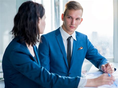 Free Photo Two Businesspeople Looking At Each Other In Office