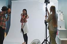 behind scenes shoot studio model photographer professional working assistant stock asking direct lighting they