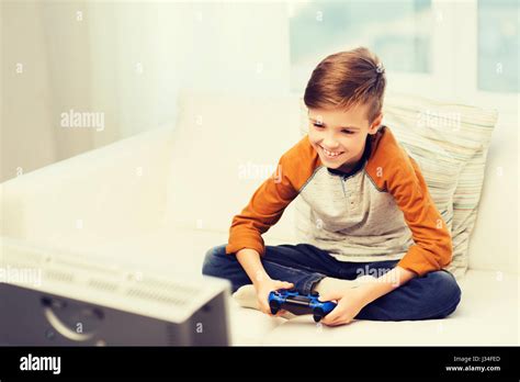 Happy Boy With Joystick Playing Video Game At Home Stock Photo Alamy