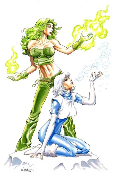 Two Women In Green And Blue Outfits One With Her Hands Out To The Other