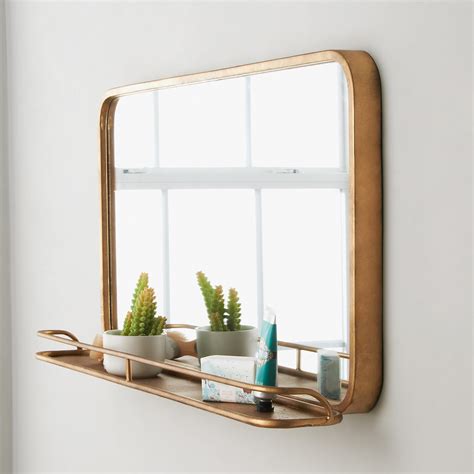 Our chrome shelf mirror is a contemporary piece with an innovative finishing touch that we love. Metal Mirror with Shelf - Large - Shades of Light