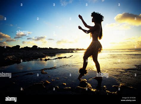 Hawaii Female Hula Dancer On Beach Silhouetted By Sunset Stock Photo