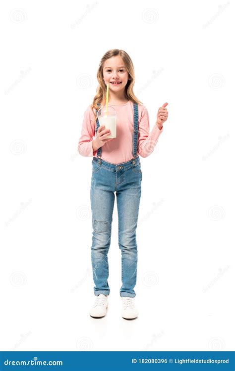 Full Length View Of Smiling Kid Holding Milkshake And Showing Thumb Up