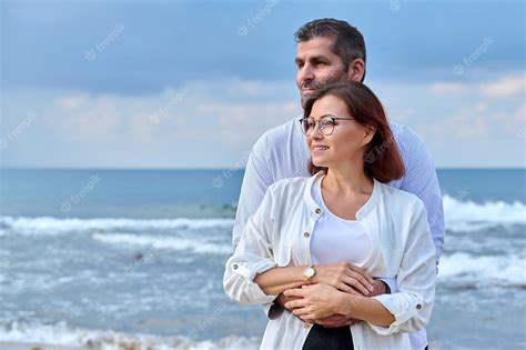 Premium Photo Outdoor Portrait Of Mature Couple Hugging On The Seashore Copy Space
