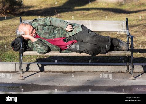 Homeless Man Sleeping On Bench High Resolution Stock Photography And