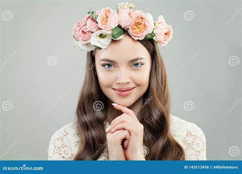 Cheerful Model Woman With Curly Hair Natural Makeup And Flowers