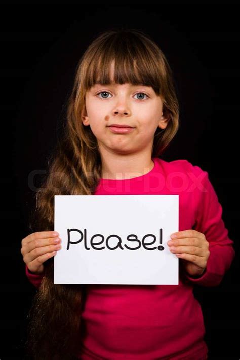 Studio Shot Of Child Holding A Please Sign Made Of White Paper With