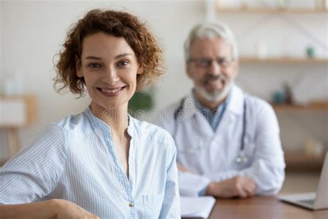 Happy Healthy Young Woman Patient Visiting Old Male Doctor Portrait