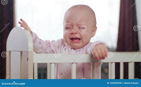 Baby Standing In A Crib At Home Crying Stock Photo Image Of Hands