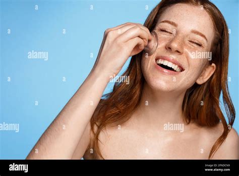 Woman using facial silicone cup cupping tool in home bathroom