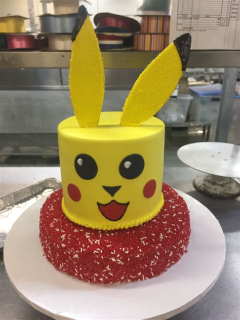 Pikachu Themed Cake With Tall Tier Pikachu Face And Sugar Ears On A Red