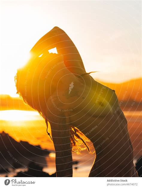 Faceless Naked Woman Standing In Sea At Sunset Time A Royalty Free Stock Photo From Photocase