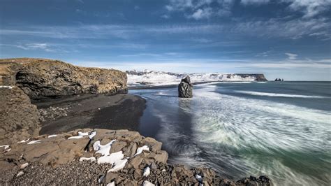 Coast Iceland Beautiful Nature Snow Covered Mountain With Seashore Under Blue White Sky During