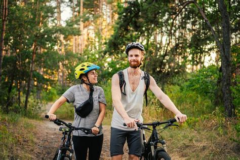 Gorgeous Couple Riding On Bikes In Park Forest Romantic Trip By