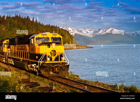An Alaska Railroad Passenger Train Rounds A Corner Along Turnagain Arm