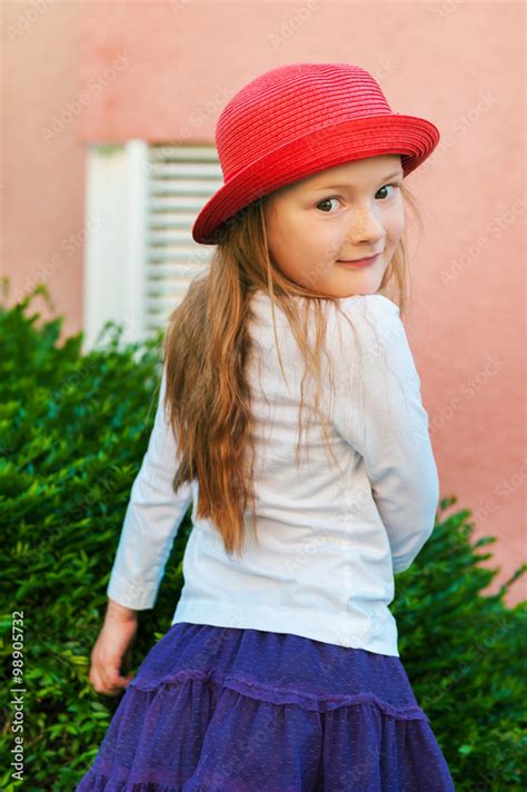 Outdoor Portrait Of A Cute Little Girl Of 5 6 Years Old Wearing Red Hat