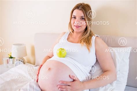 Pregnant Woman Lying On Bed By Wavebreakmedia Mostphotos