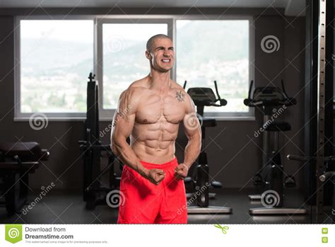 Muscular Man Flexing Muscles In Gym Stock Image Image Of Flexing