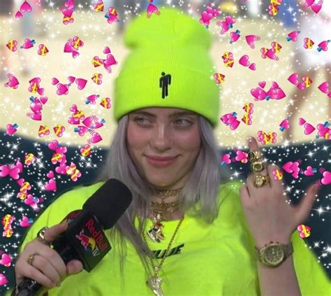 A Woman With Blonde Hair Wearing A Neon Green Hat And Holding A