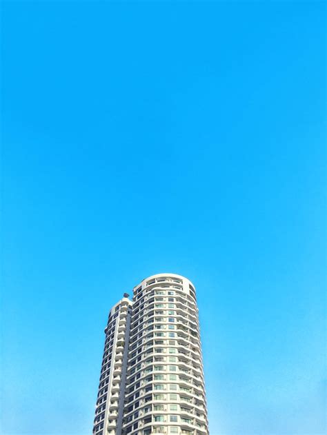 White And Blue Concrete Building Under Blue Sky During Daytime Photo