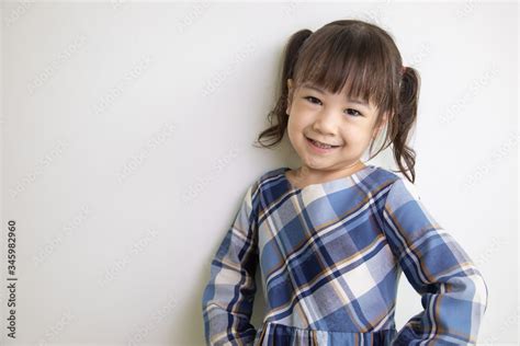 Half Body And Front View Photo Of Adorable Three Year Old Asian Girl Posing On A White