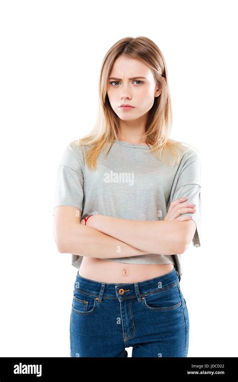 portrait of an angry disappointed girl standing with arms folsed and looking at camera isolated