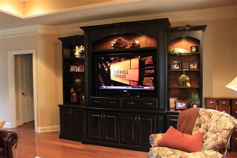 A Living Room With A Large Entertainment Center In The Middle Of Its Wall