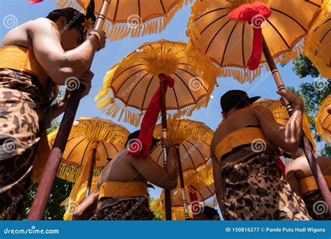 Group Of Balinese Men In Traditional Costumes Play Gamelan Music