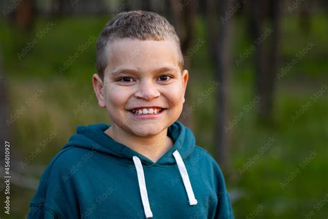 Head And Shoulders Of Ten Year Old Indigenous Boy Smiling At Camera