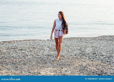 Beautiful Woman With Long Hair On The Beach By The Sea At Dawn Stock Image Image Of Lifestyle