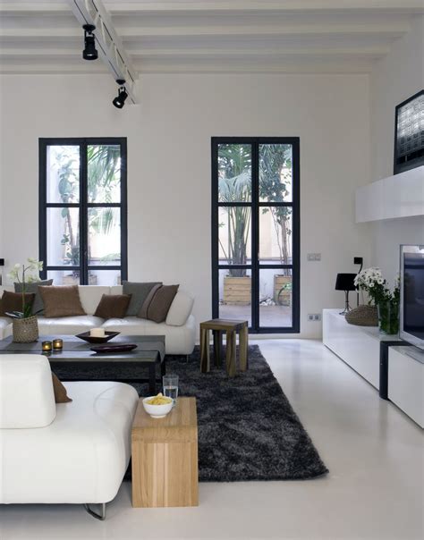 This room's design establishes a clear center point by using a square, sturdy coffee table that is a different, darker color than the rest of the room. Minimalist Living Room Apartment Ideas - Interior Design Ideas