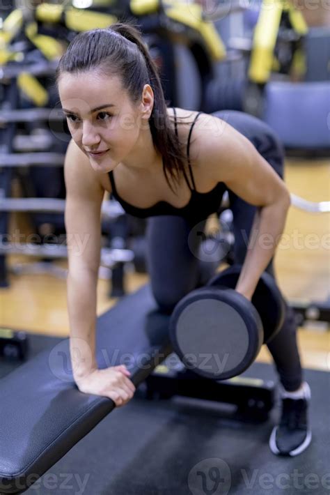 Woman Doing A Workout With Dumbbells At The Fitness Gym Stock
