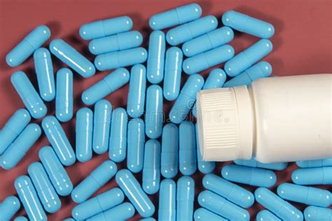 Blue Antibiotic Capsule Pills Texture With White Bottle Pharmaceutical