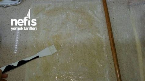A Person Using A Brush To Clean A Tile Floor With A Netis Logo On It