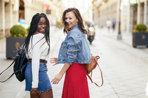 Two Female Friends Having Fun Together On The Street Multiethnic
