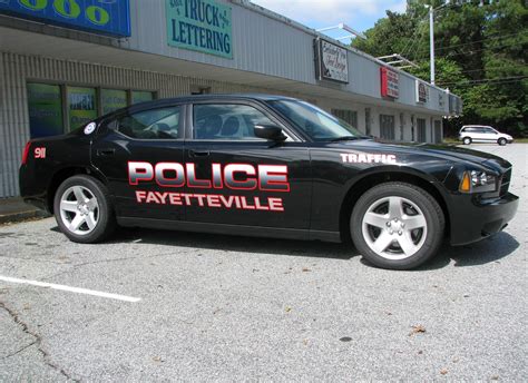Fayetteville City Police with fading letters and reflective outlines