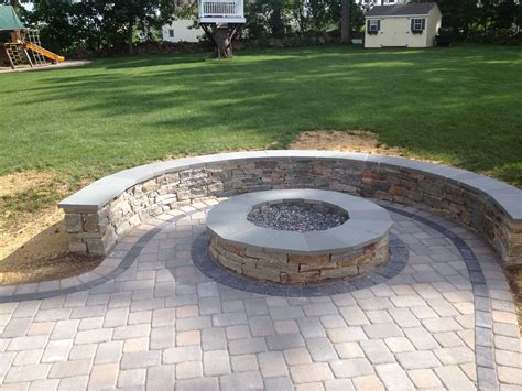 Natural Stone Sitting Wall With Bluestone Cap Surrounds A Fire Pit And