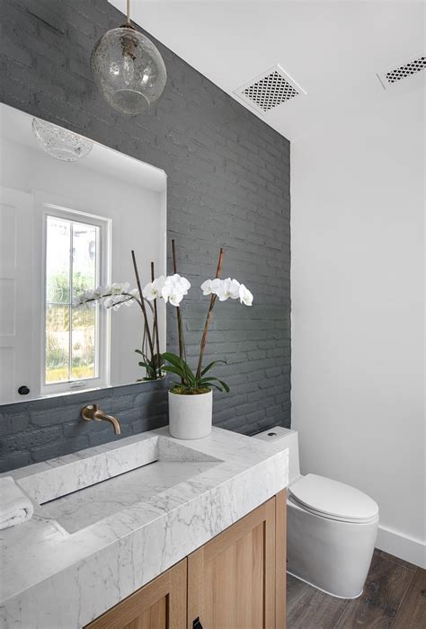 Powder Room Features A Brick Accent Wall Painted In Farrow And Ball