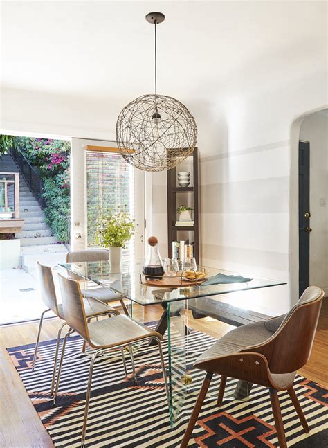 Gorgeous tuscan style dining room features a round, ornate table and large chairs on top a large area rug. 20 Small Dining Rooms That Make The Most Out of Limited Space